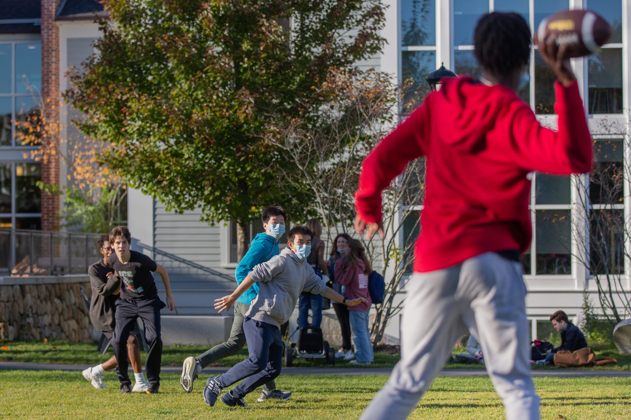 Students playing football on the quad