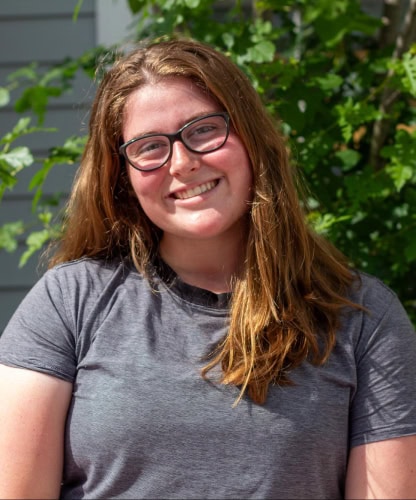 Woman with glasses posing for a photo