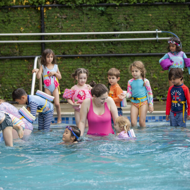 Campers swimming in the pool.