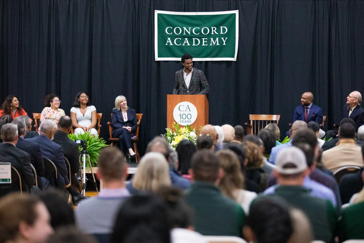 Picture of a man giving a speech in front of a crowd of people at Concord Academy's installation ceremony
